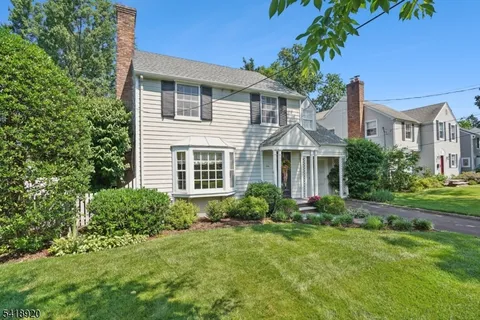a view of a house with garden and yard