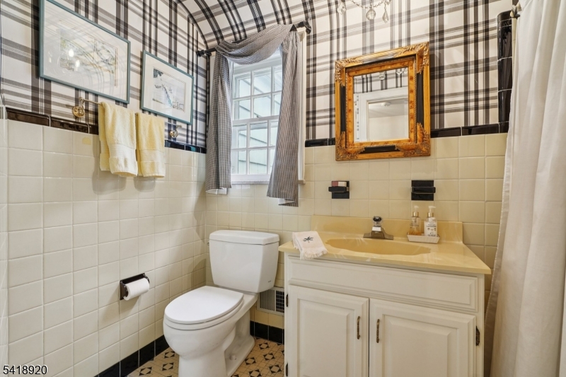 66 Springbrook Road Springfield, NJ 07081 - Photo 31 of 38 a bathroom with a granite countertop toilet sink and a mirror
