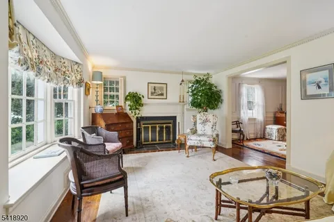 a living room with furniture a fireplace and a large window