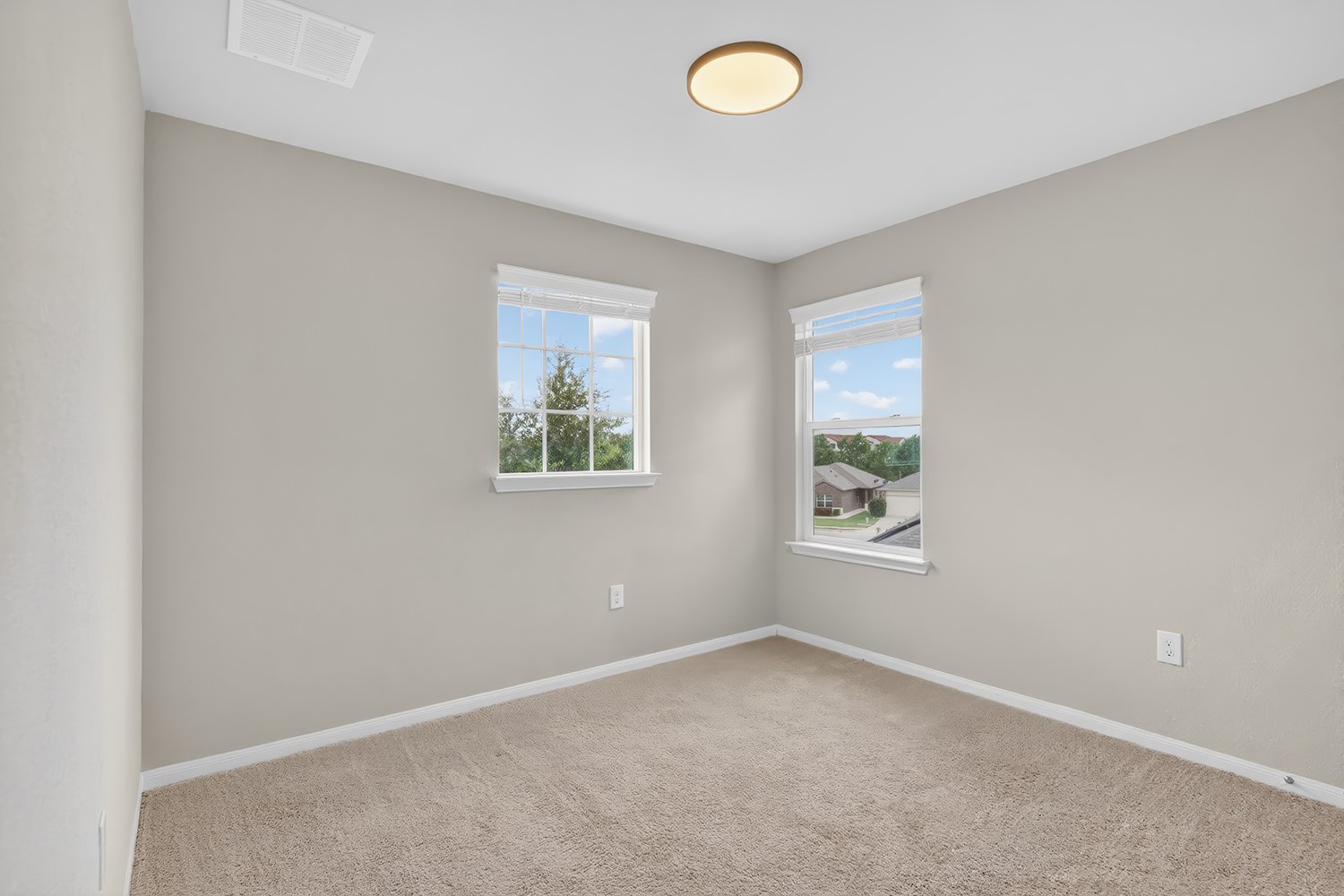 2006 Grow Lane Austin, TX 78754 - Photo 21 of 40 A well-lit bedroom features plush carpeting and multiple windows.