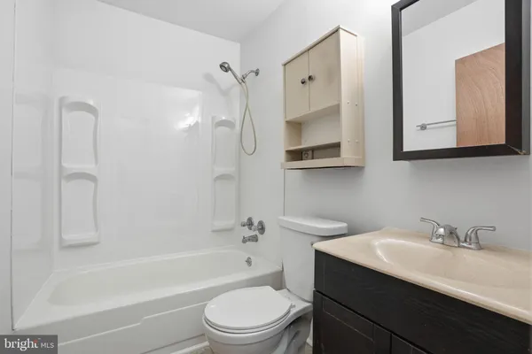 a bathroom with a sink a toilet and bathtub