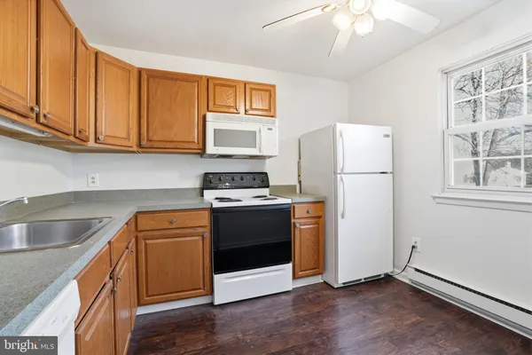 a kitchen with stainless steel appliances granite countertop a refrigerator sink and stove