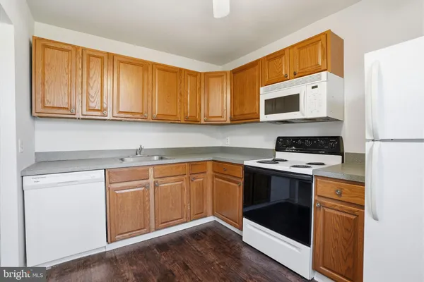a kitchen with stainless steel appliances granite countertop a stove and a microwave
