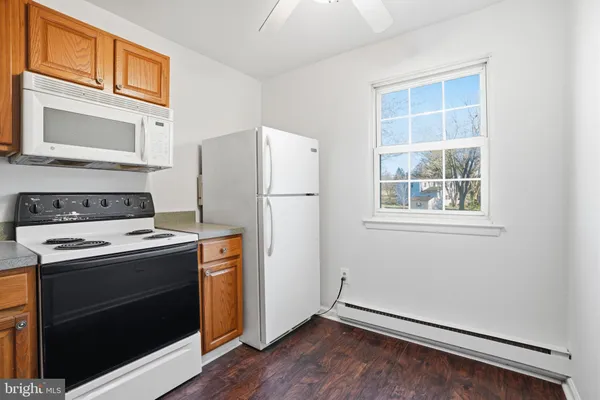 a kitchen with a stove a refrigerator and a window
