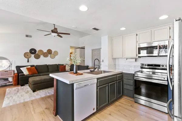 a kitchen with a stove sink and a refrigerator