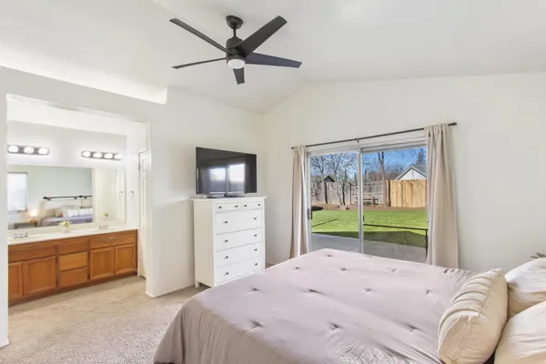 a bedroom with a bed and a television