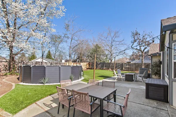 a view of a house with a yard and sitting area