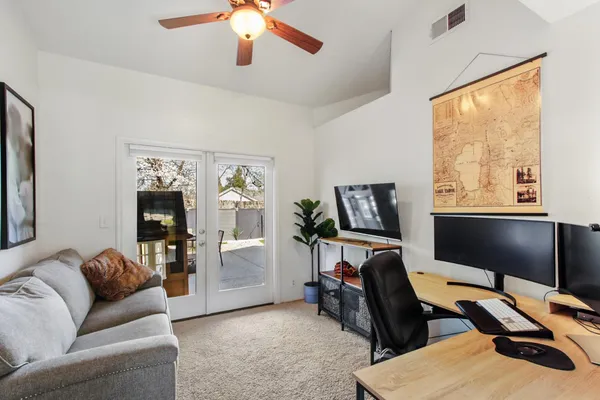 a view of a livingroom with workspace and a window