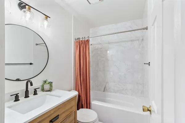 a bathroom with a sink toilet and shower