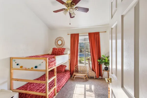 a bedroom with a bed and a window