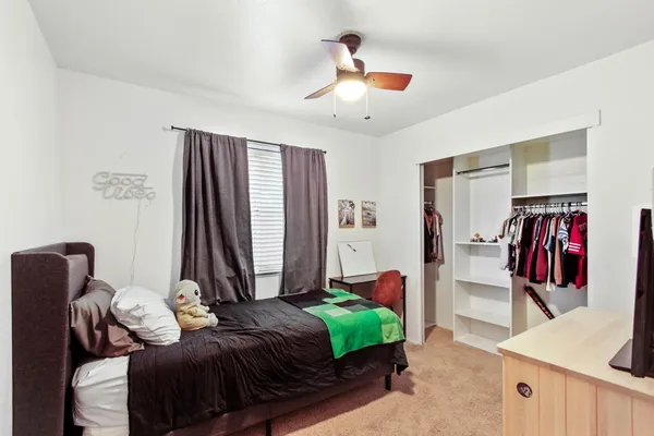 a bedroom with a bed and a chandelier