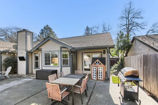 a front view of a house with outdoor seating