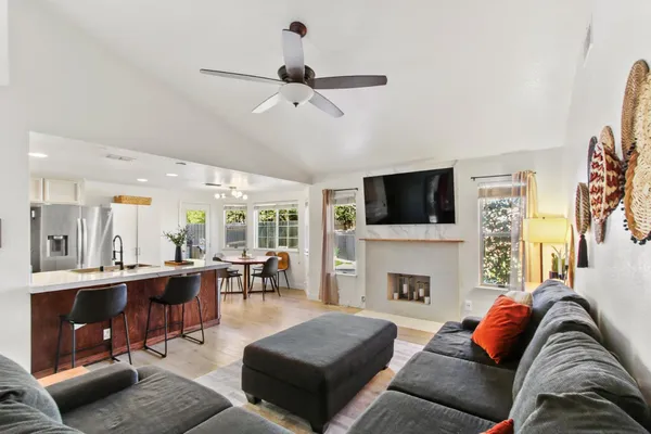 a living room with furniture fireplace and a flat screen tv