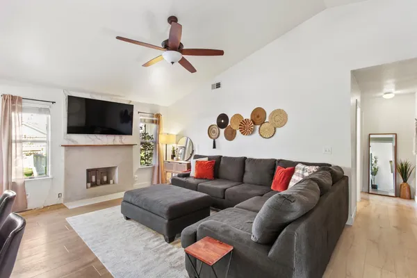 a living room with furniture fireplace and flat screen tv