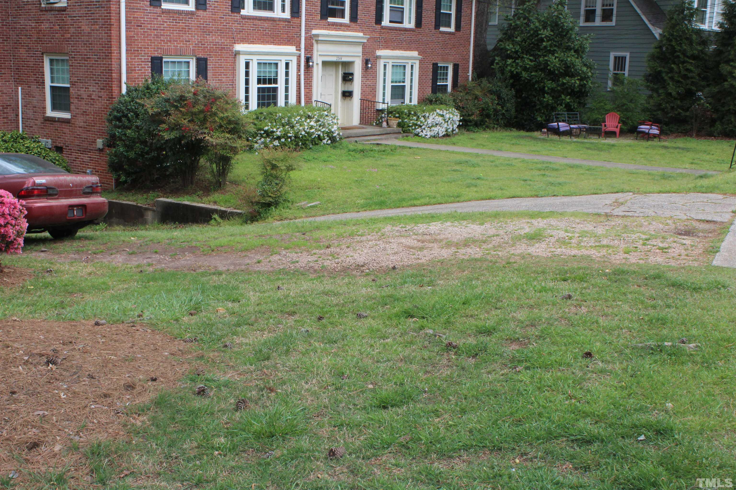 2248 The Circle, Unit 2 Raleigh, NC 27608 - Photo 20 of 21 a view of a brick house with a yard