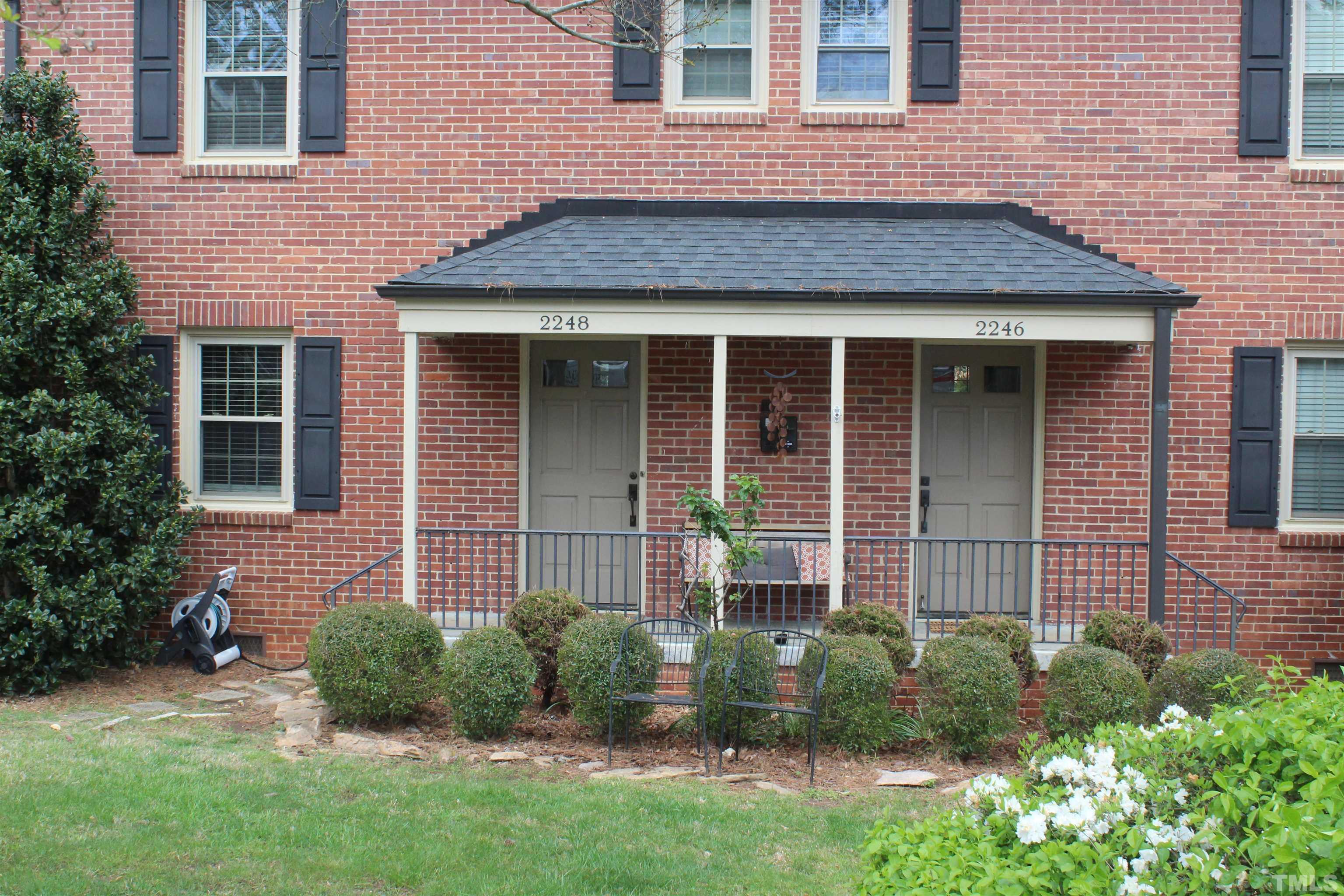 2248 The Circle, Unit 2 Raleigh, NC 27608 - Photo 2 of 21 a front view of a house with garden