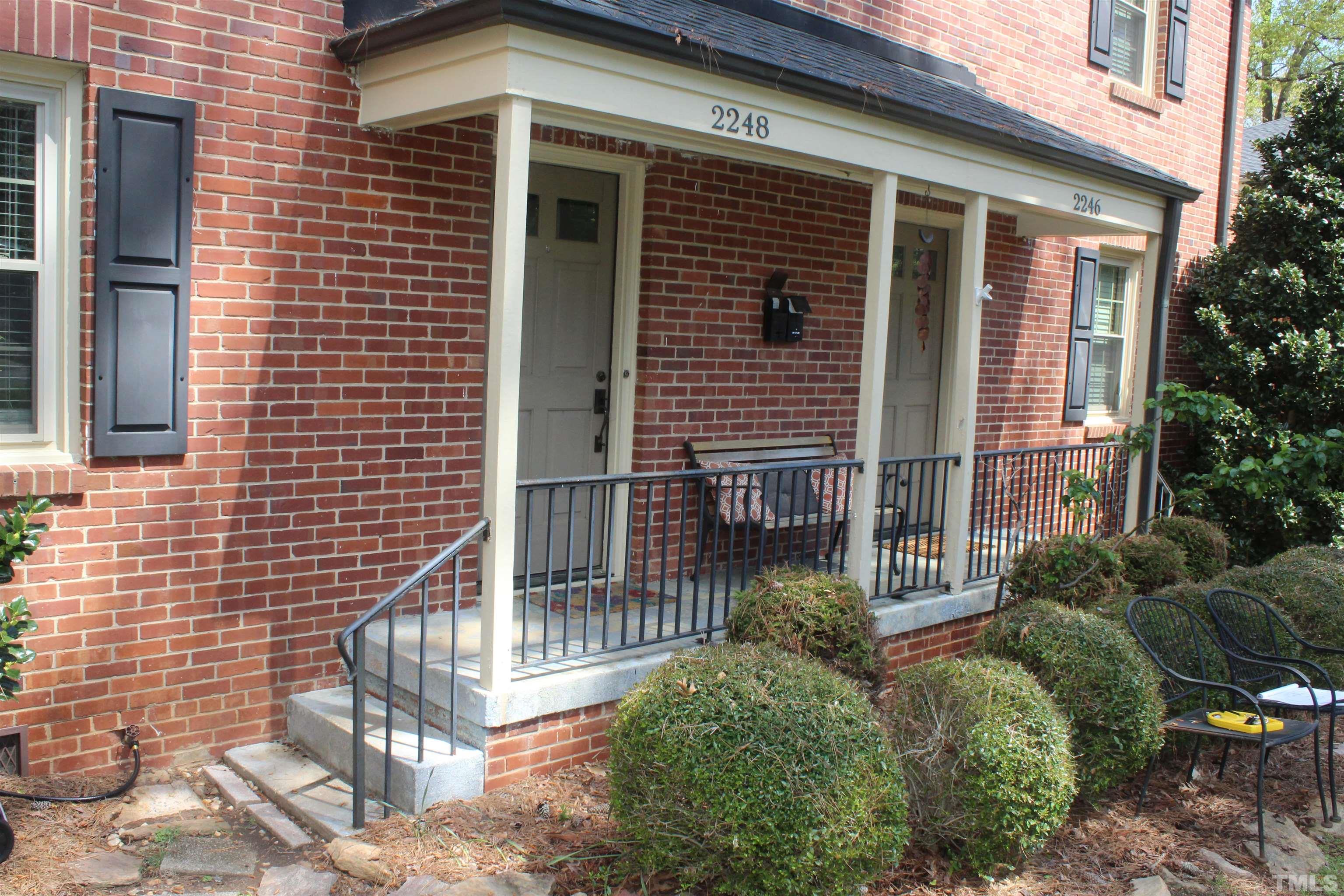 2248 The Circle, Unit 2 Raleigh, NC 27608 - Photo 3 of 21 a view of a house with wooden fence and potted plants