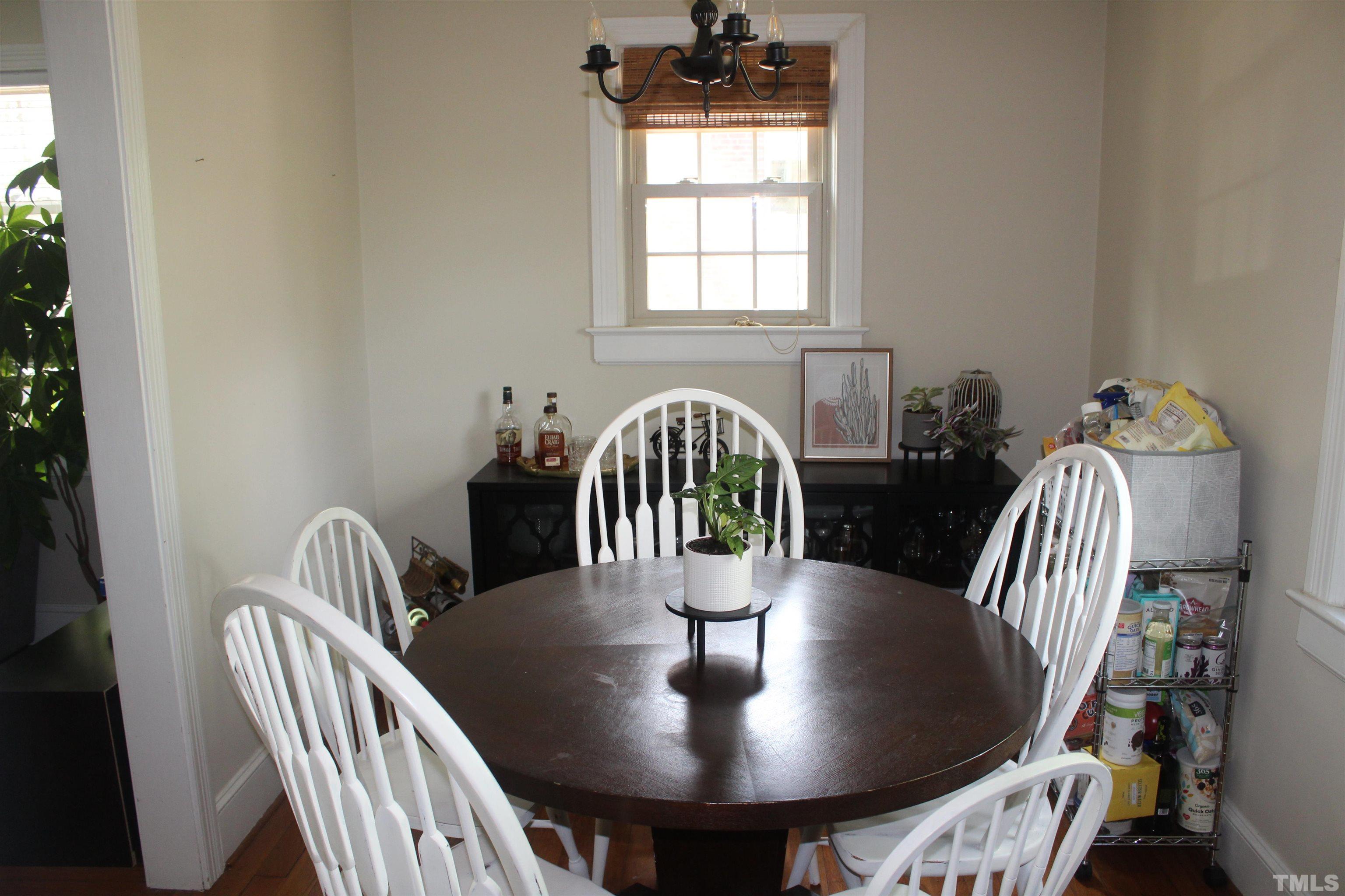 2248 The Circle, Unit 2 Raleigh, NC 27608 - Photo 6 of 21 a dining room with furniture and wooden floor