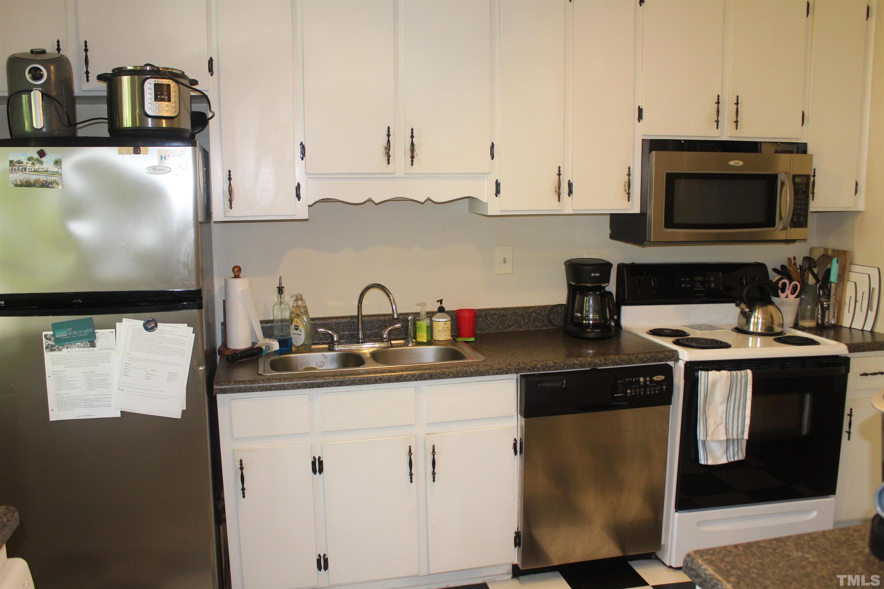 2248 The Circle, Unit 2 Raleigh, NC 27608 - Photo 8 of 21 a kitchen with stainless steel appliances granite countertop a sink stove and microwave