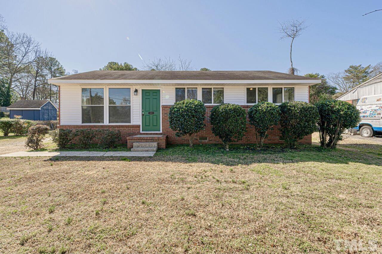828 Newcombe Road Raleigh, NC 27610 - Photo 1 of 24 a front view of a house with garden