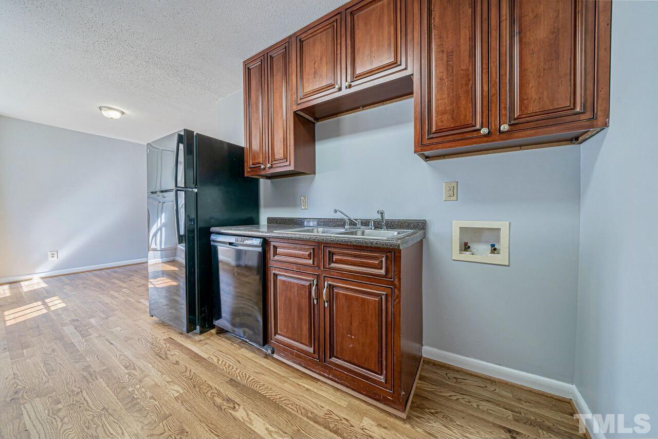 828 Newcombe Road Raleigh, NC 27610 - Photo 13 of 24 a kitchen with stainless steel appliances granite countertop a refrigerator and a stove top oven