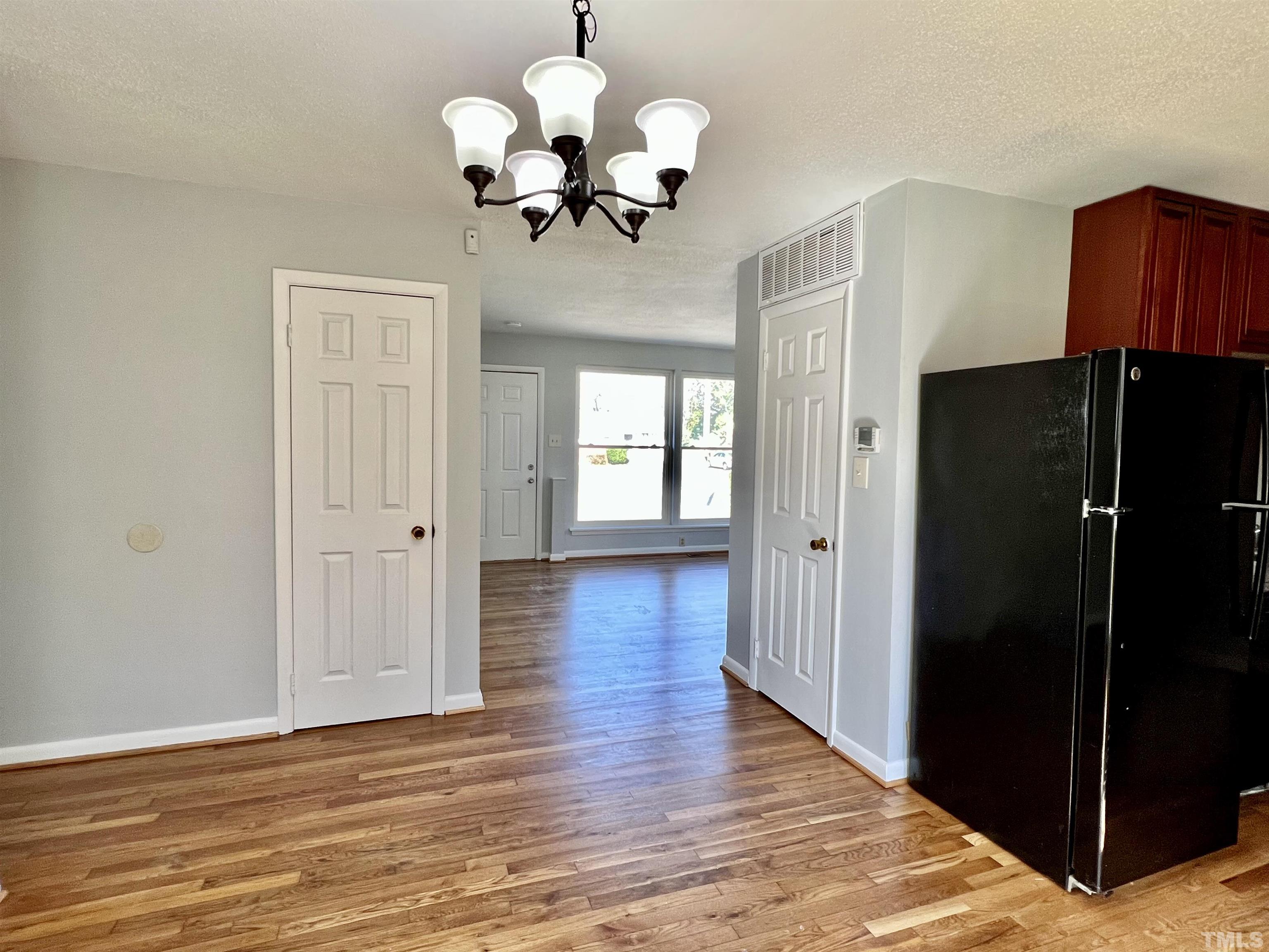 828 Newcombe Road Raleigh, NC 27610 - Photo 15 of 24 a view of a room with wooden floor chandelier and closet