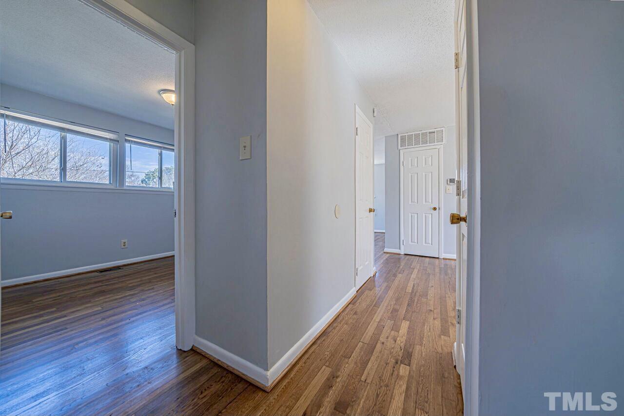 828 Newcombe Road Raleigh, NC 27610 - Photo 17 of 24 wooden floor in a empty room with a window