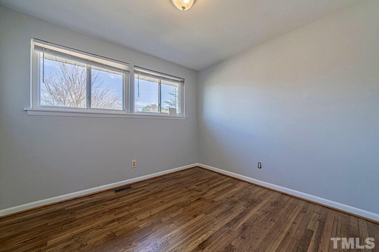 828 Newcombe Road Raleigh, NC 27610 - Photo 18 of 24 wooden floor in an empty room with a window