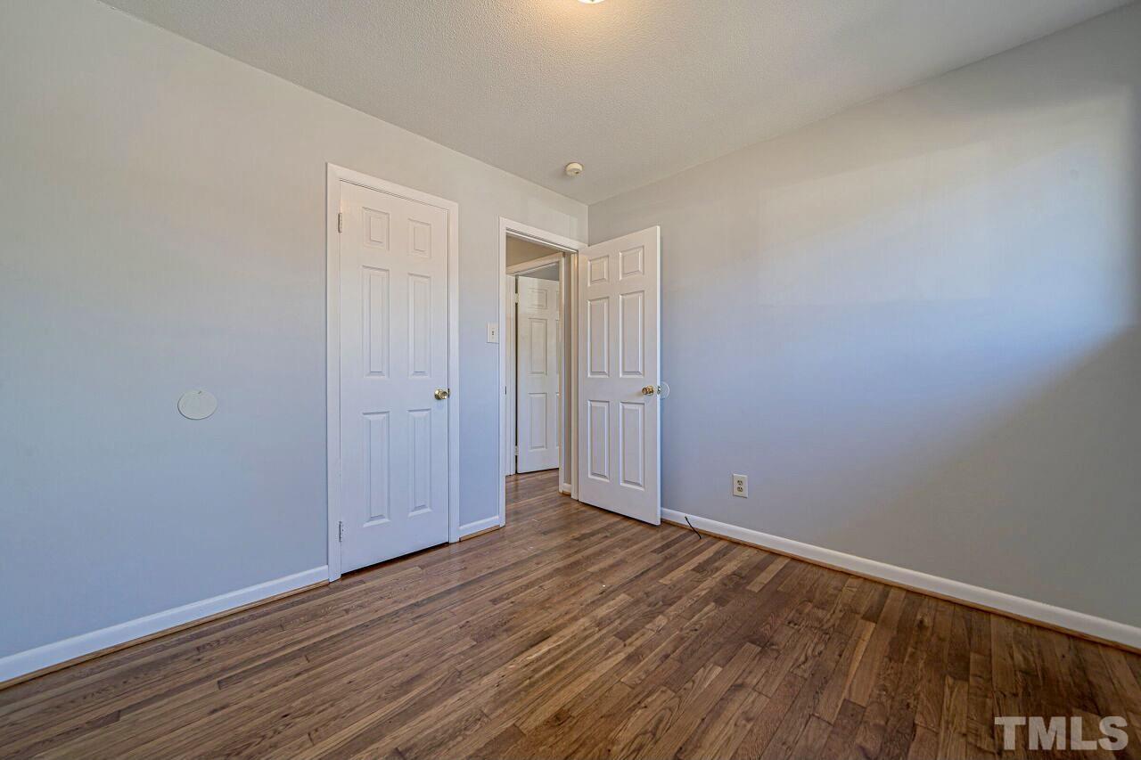 828 Newcombe Road Raleigh, NC 27610 - Photo 19 of 24 a view of an empty room with wooden floor
