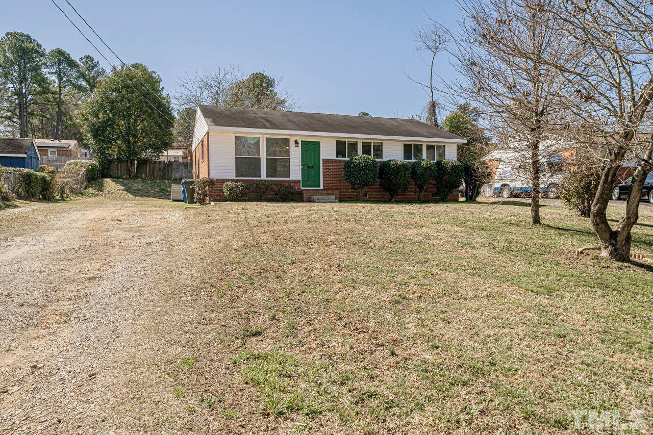 828 Newcombe Road Raleigh, NC 27610 - Photo 2 of 24 a front view of a house with a yard and garage
