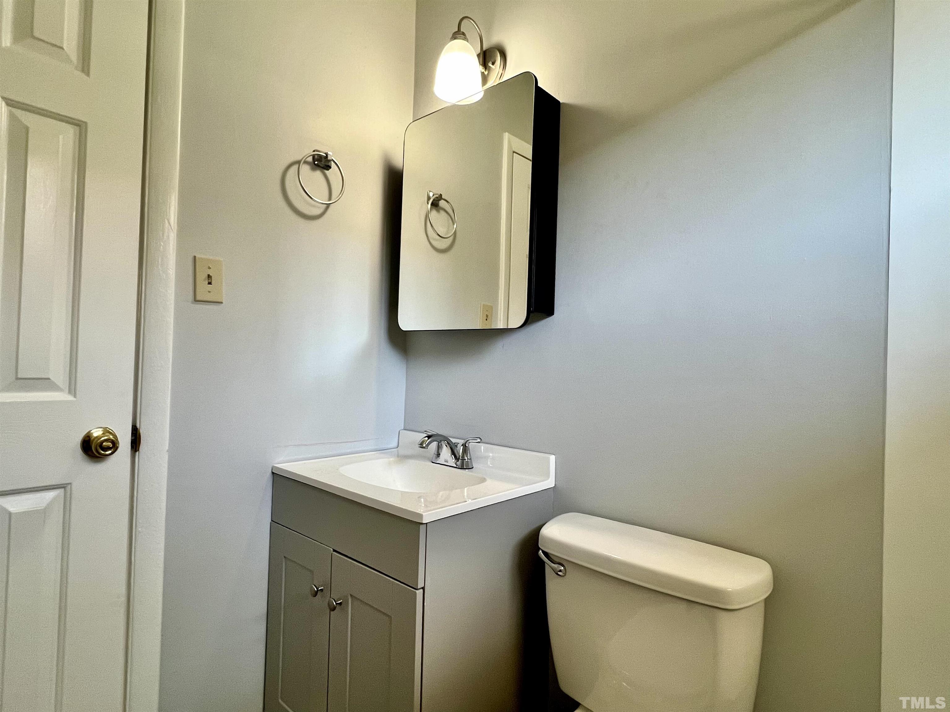 828 Newcombe Road Raleigh, NC 27610 - Photo 24 of 24 a bathroom with a toilet sink and mirror