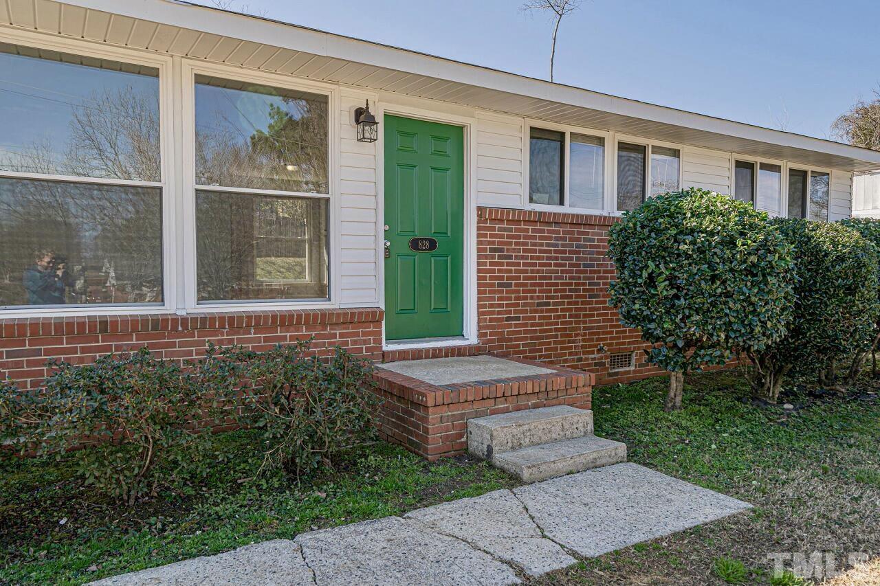 828 Newcombe Road Raleigh, NC 27610 - Photo 3 of 24 a view of a brick house with a yard