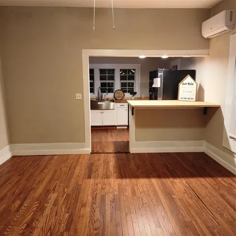 a view of a room with wooden floor and windows