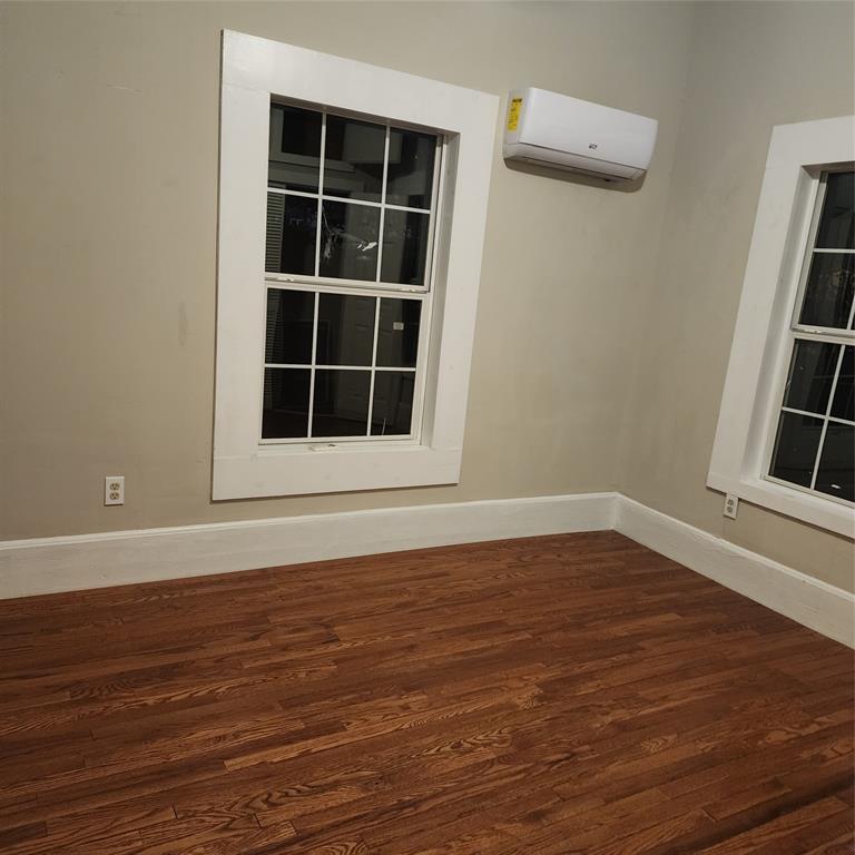 827 East Carroll Street Coushatta, LA 71019 - Photo 6 of 10 a view of an empty room with wooden floor and windows