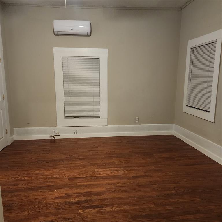 827 East Carroll Street Coushatta, LA 71019 - Photo 7 of 10 a view of an empty room with wooden floor and a window