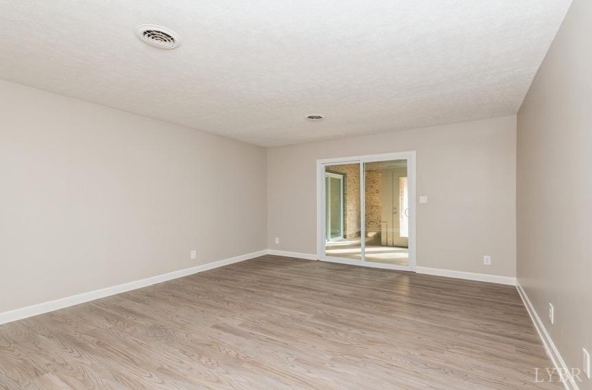 1180 David Giles Lane Blairs, VA 24527 - Photo 15 of 34 a view of an empty room with wooden floor and a window