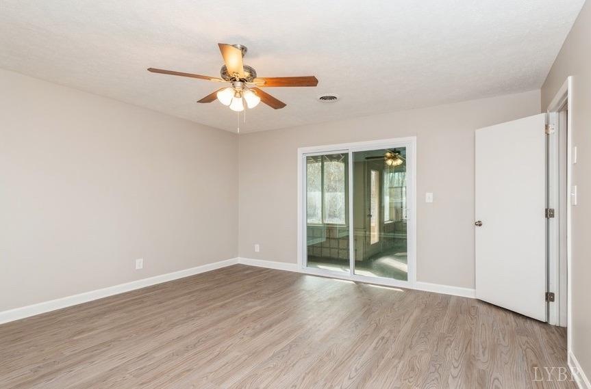 1180 David Giles Lane Blairs, VA 24527 - Photo 22 of 34 an empty room with wooden floor fan and windows