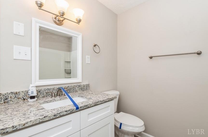 1180 David Giles Lane Blairs, VA 24527 - Photo 30 of 34 a bathroom with a granite countertop sink and a mirror
