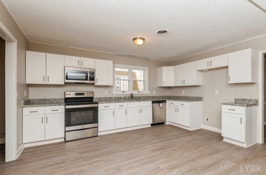 1180 David Giles Lane Blairs, VA 24527 - Photo 8 of 34 a kitchen with granite countertop white cabinets and stainless steel appliances