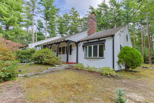 a house that has a tree in front of the house