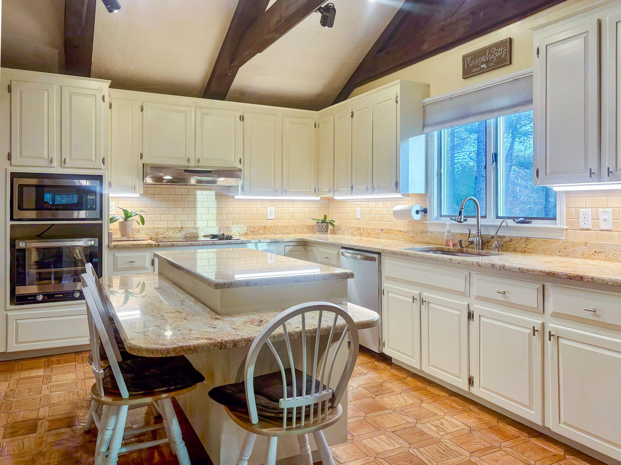 28 Brook Street Plympton, MA 02367 - Photo 26 of 57 a kitchen with stainless steel appliances granite countertop a table chairs sink and cabinets