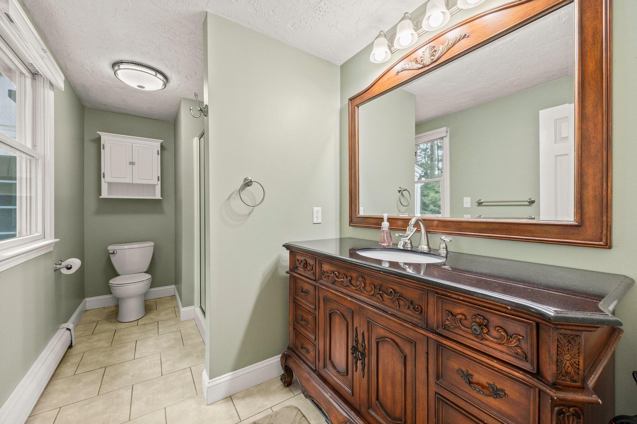 28 Brook Street Plympton, MA 02367 - Photo 32 of 57 a bathroom with a sink a toilet and mirror
