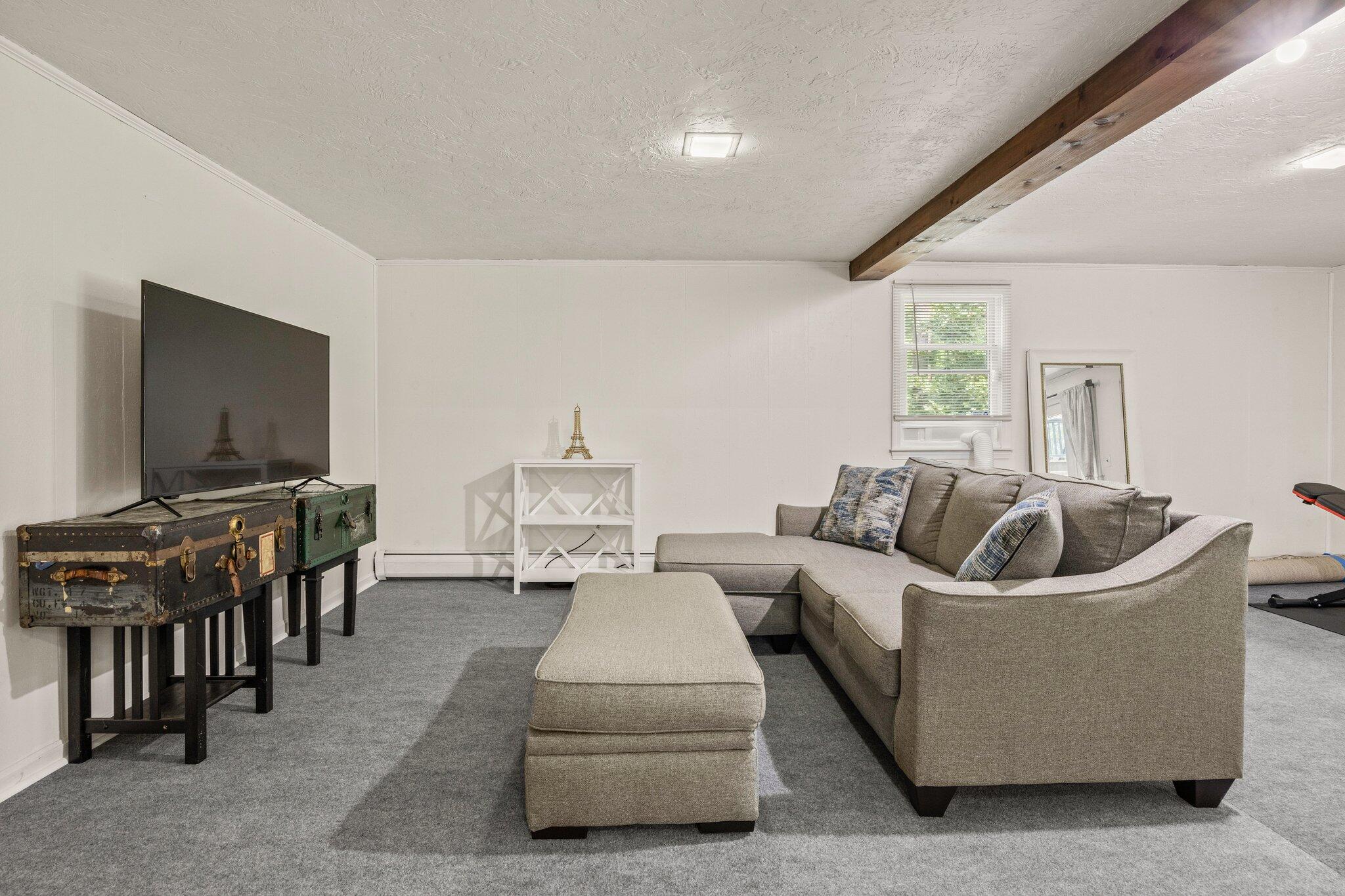 28 Brook Street Plympton, MA 02367 - Photo 43 of 57 a living room with furniture and a flat screen tv