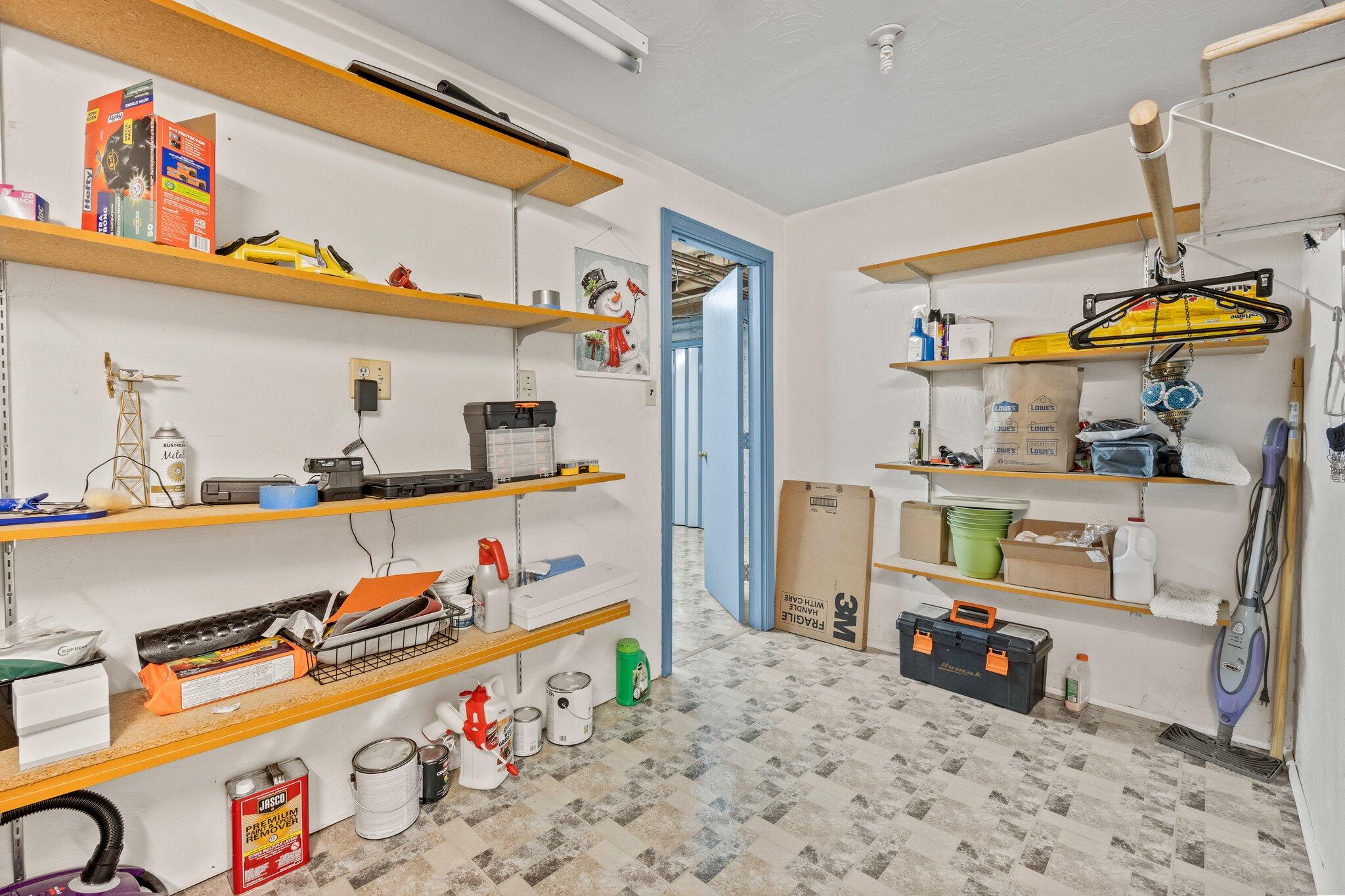 28 Brook Street Plympton, MA 02367 - Photo 49 of 57 a storage room with lots of clutter and cabinets