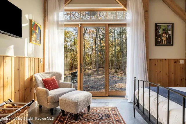 a living room with furniture and a floor to ceiling window