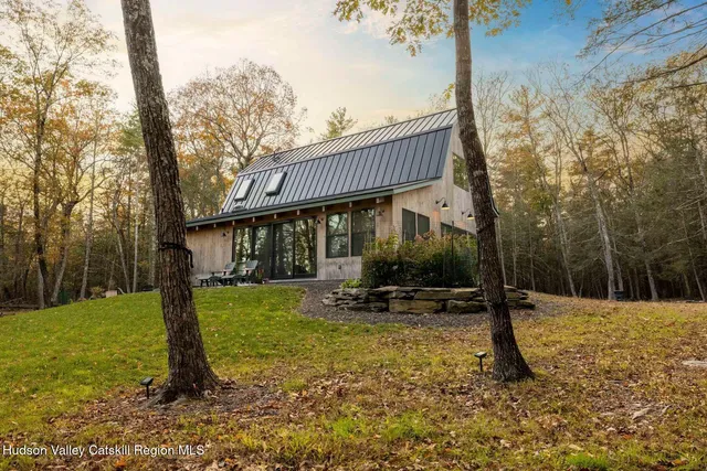 a backyard of a house with table and chairs