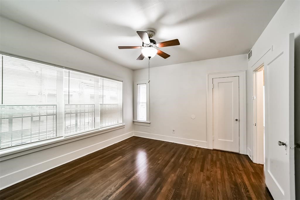 2235 Welch Street Houston, TX 77019 - Photo 13 of 18 wooden floor in an empty room with a window