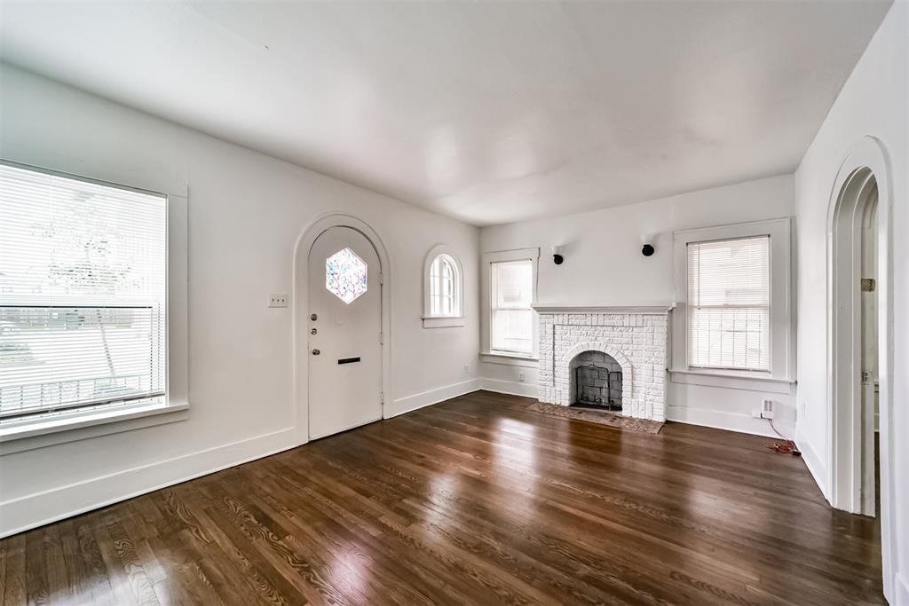 2235 Welch Street Houston, TX 77019 - Photo 4 of 18 an empty room with windows fireplace and sink
