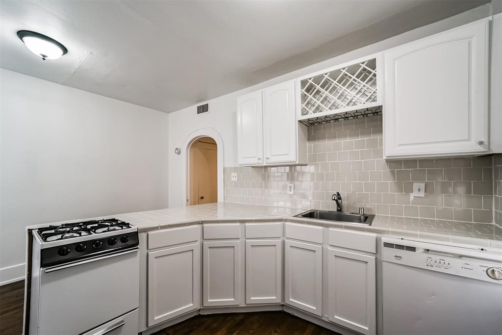 2235 Welch Street Houston, TX 77019 - Photo 8 of 18 a kitchen with stainless steel appliances granite countertop a sink and cabinets