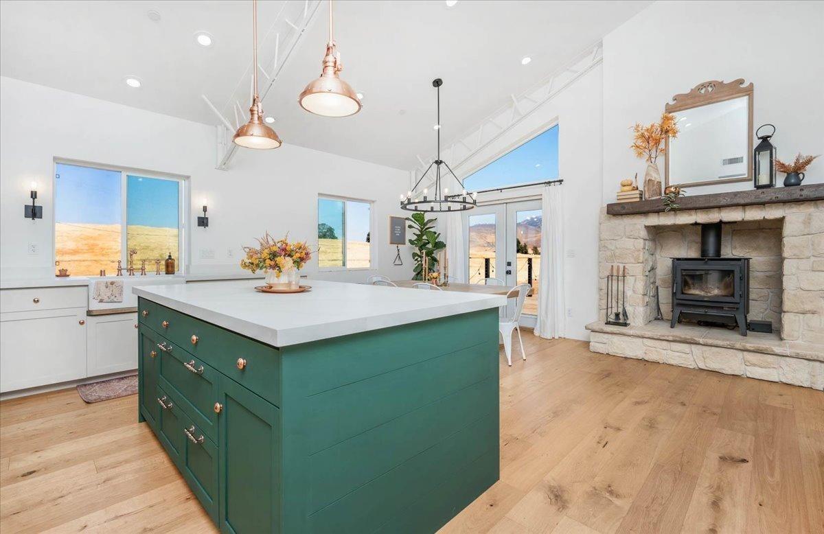 22654 Cobblestone Lane Sanger, CA 93657 - Photo 24 of 64 a kitchen with a sink and a fireplace